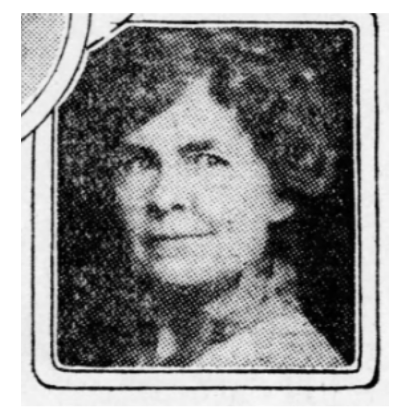 Black and white portrait photo of a woman smiling and looking slighty off camera.