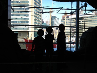 Figure 3.2: Three children silhouetted by window overlooking Baltimore