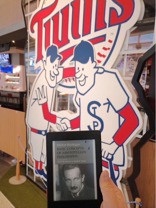 Figure 2: E-reader displaying Martin Heidegger's *Basic Concepts of Aristotelian Philosophy* in front of Twins sign